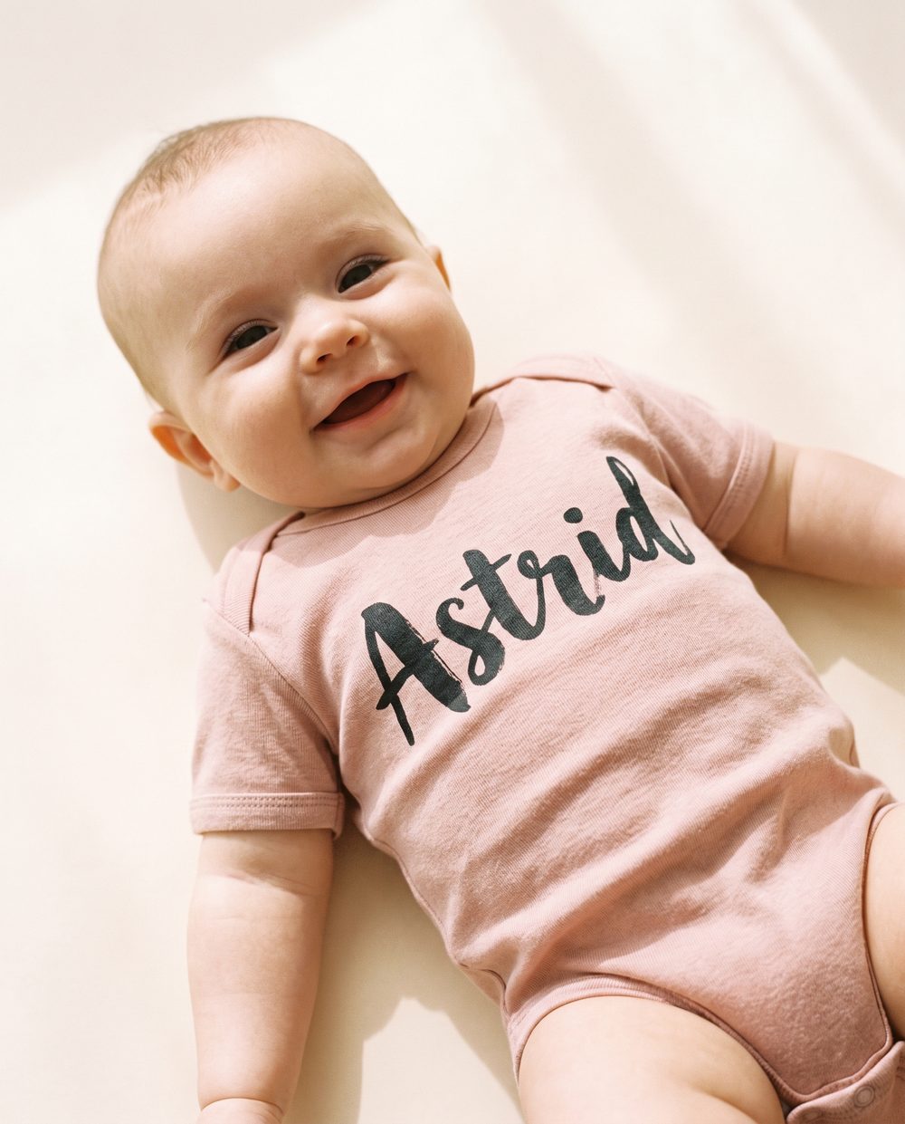 “Astrid” on a Pink bodysuit