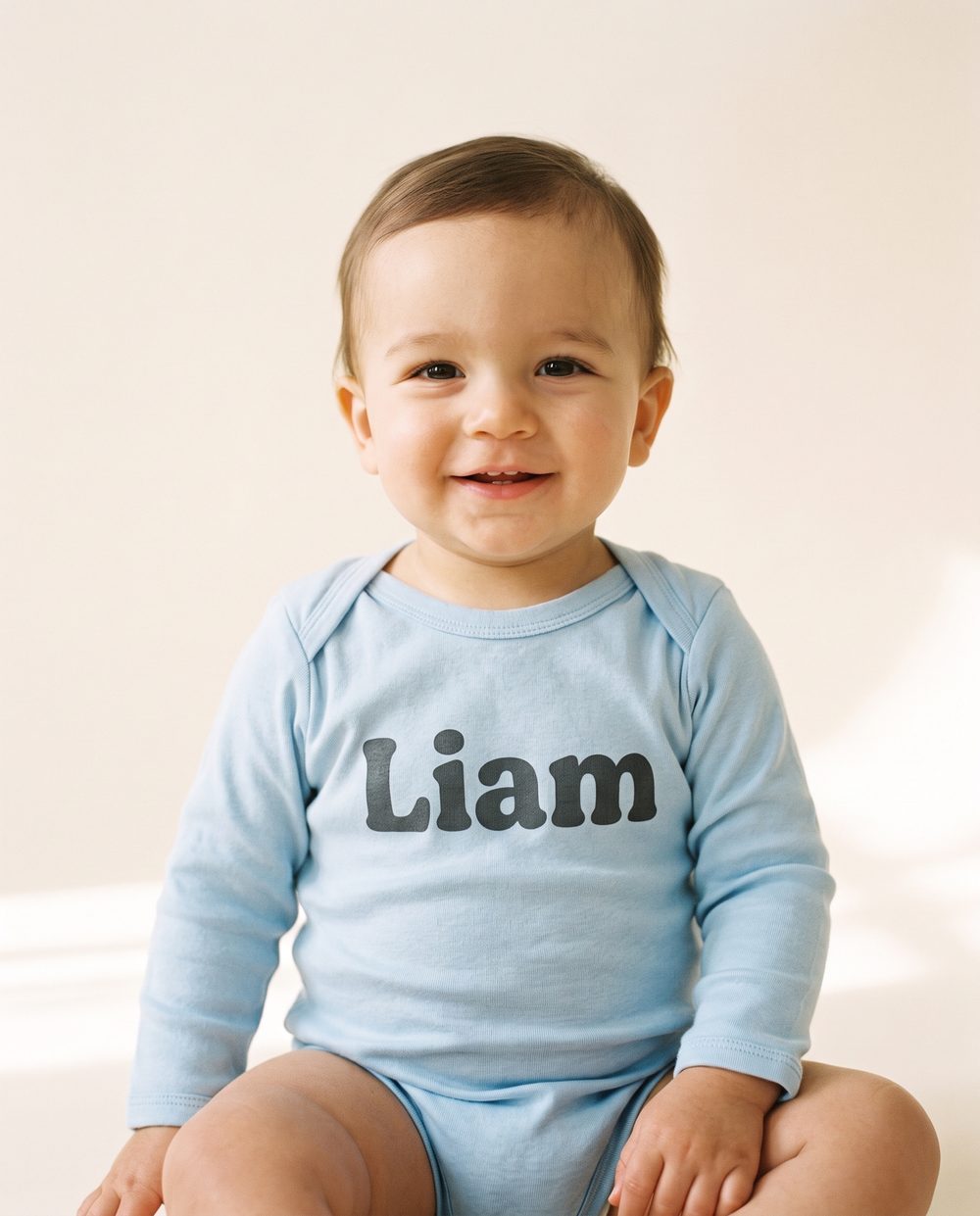 “Liam” on a Baby-blue bodysuit